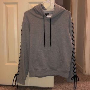 Grey hoodie with laces on sleeves